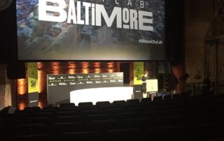 CityLab Baltimore event stage and screen.